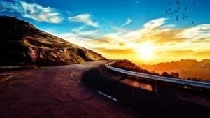sunset on an open road for RV travel destinations
