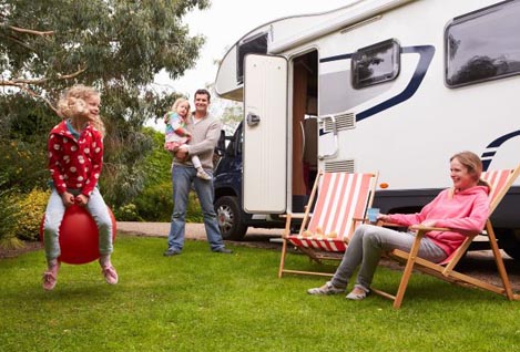 Family in front of RV with RV warranty and RV insurance